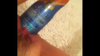 Toying with suncream  bottle